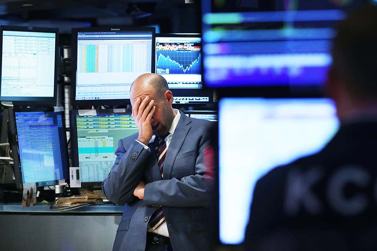 A trader works on the floor of the New York Stock Exchange (NYSE) on October 15, 2014 in New York City. As fears from Ebola and a global slowdown spread, stocks plunged on Wednesday with the Dow falling over 400 points during the afternoon before recovering slightly