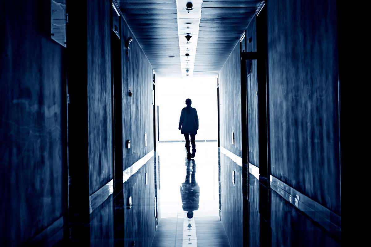 Figure walking down corridor