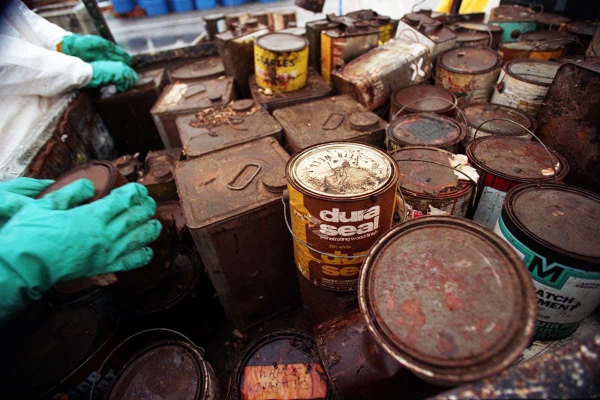 Rusty tins of assorted household chemicals