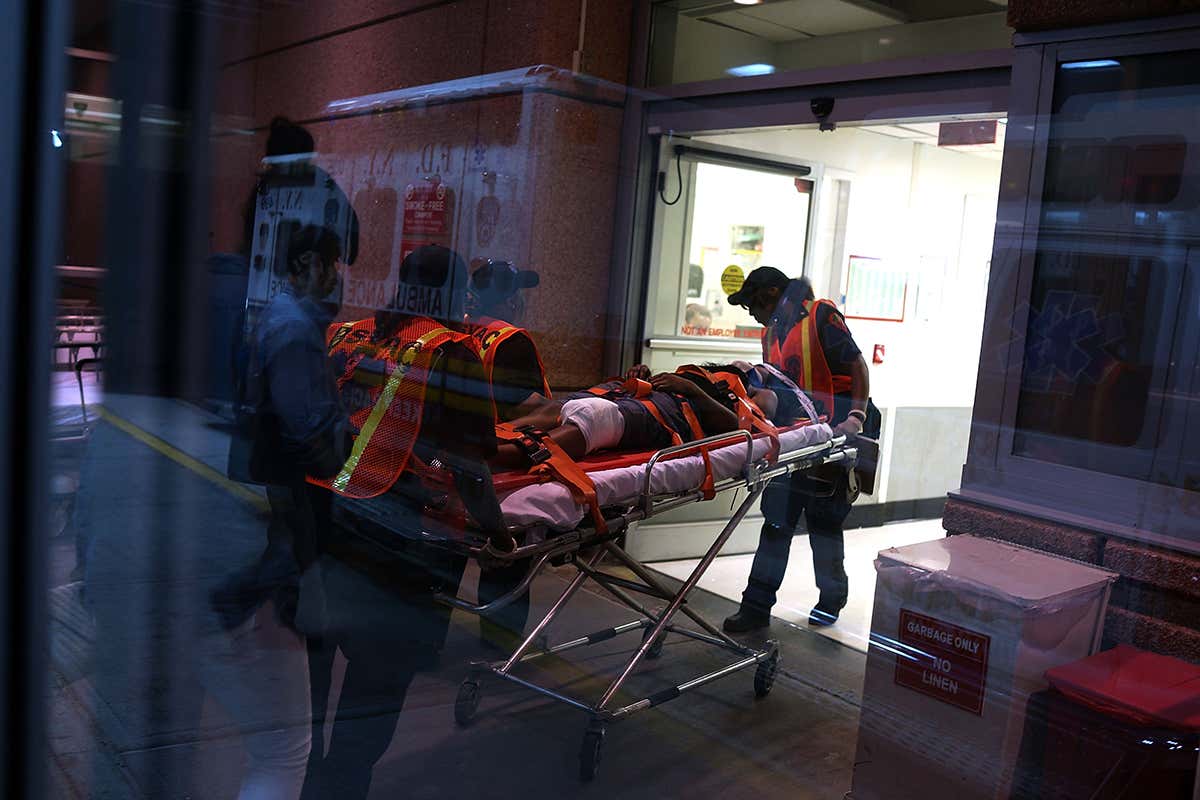 An injured person being wheeled into hospital