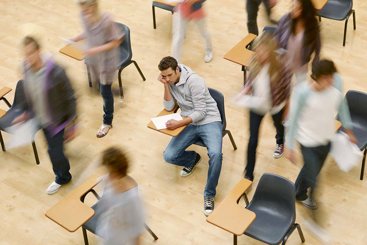 A male student sitting an exam