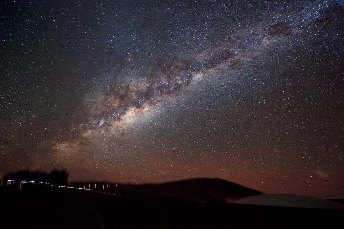 Milky Way visible in the sky above some mountains