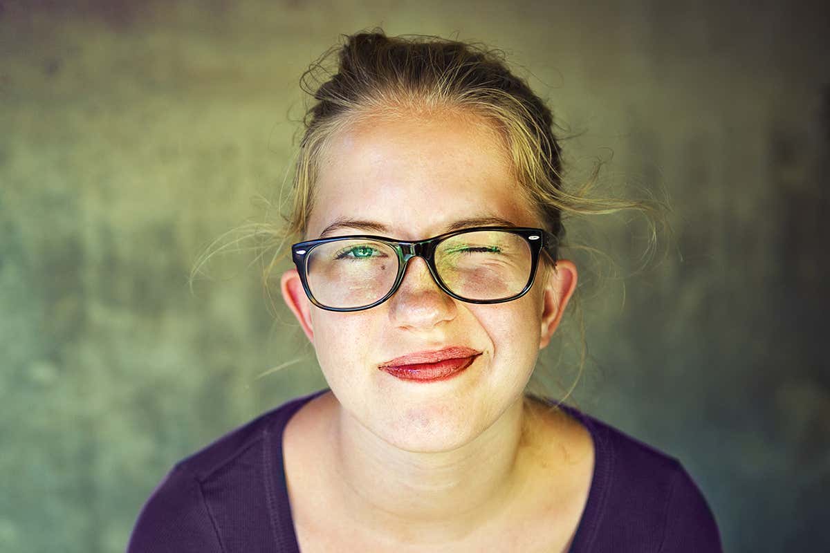 woman blinking while wearing glasses