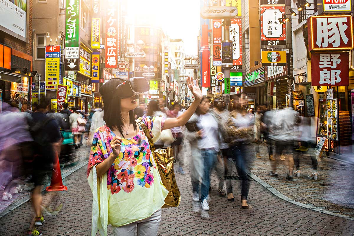 A person walking down a busy street is wearing an augmented reality headset