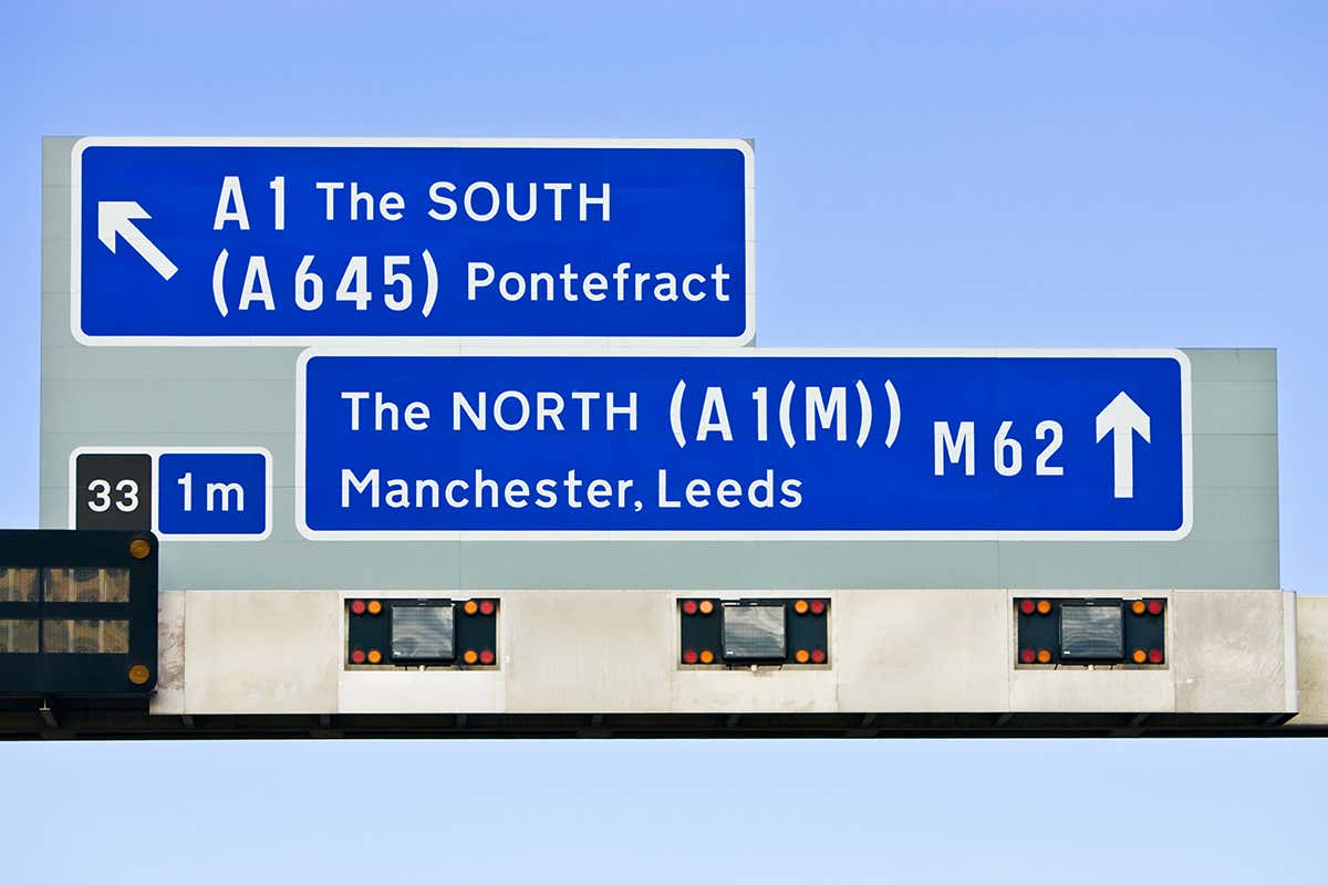 Road signs to north and south of England