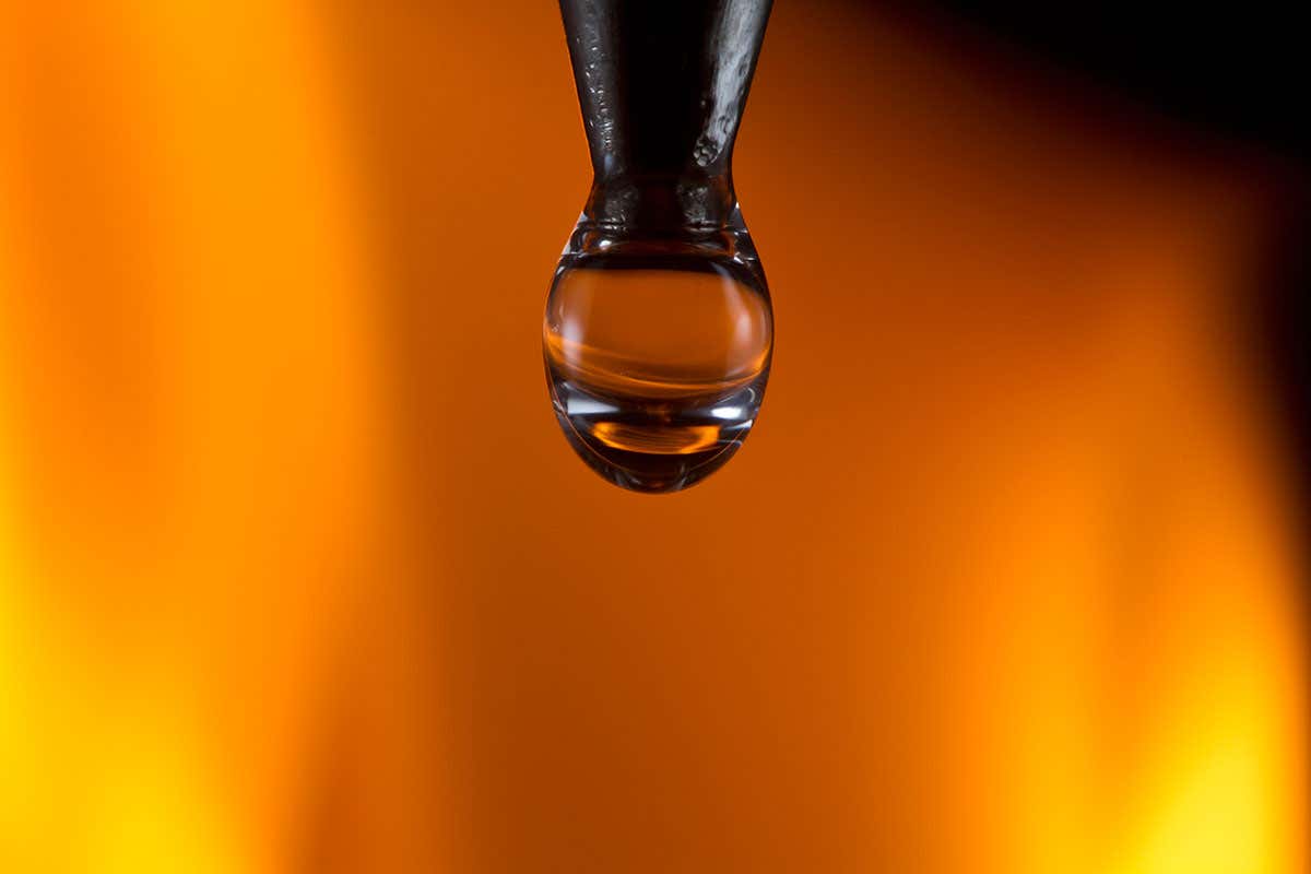 A water droplet against a background of flames