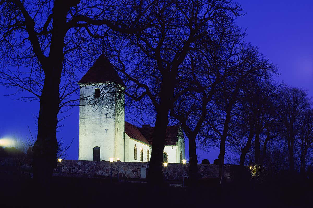 Floodlit church against a midnight blue sky