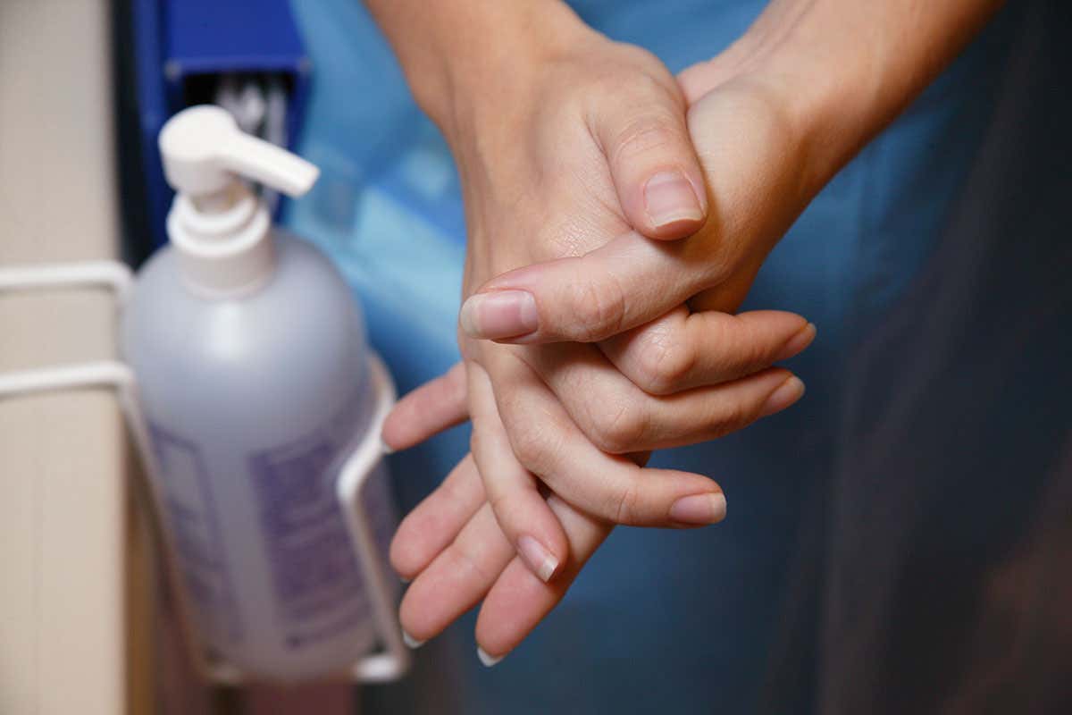 A woman washing her hands with handwash