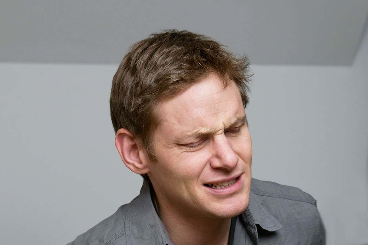 A man wincing in pain