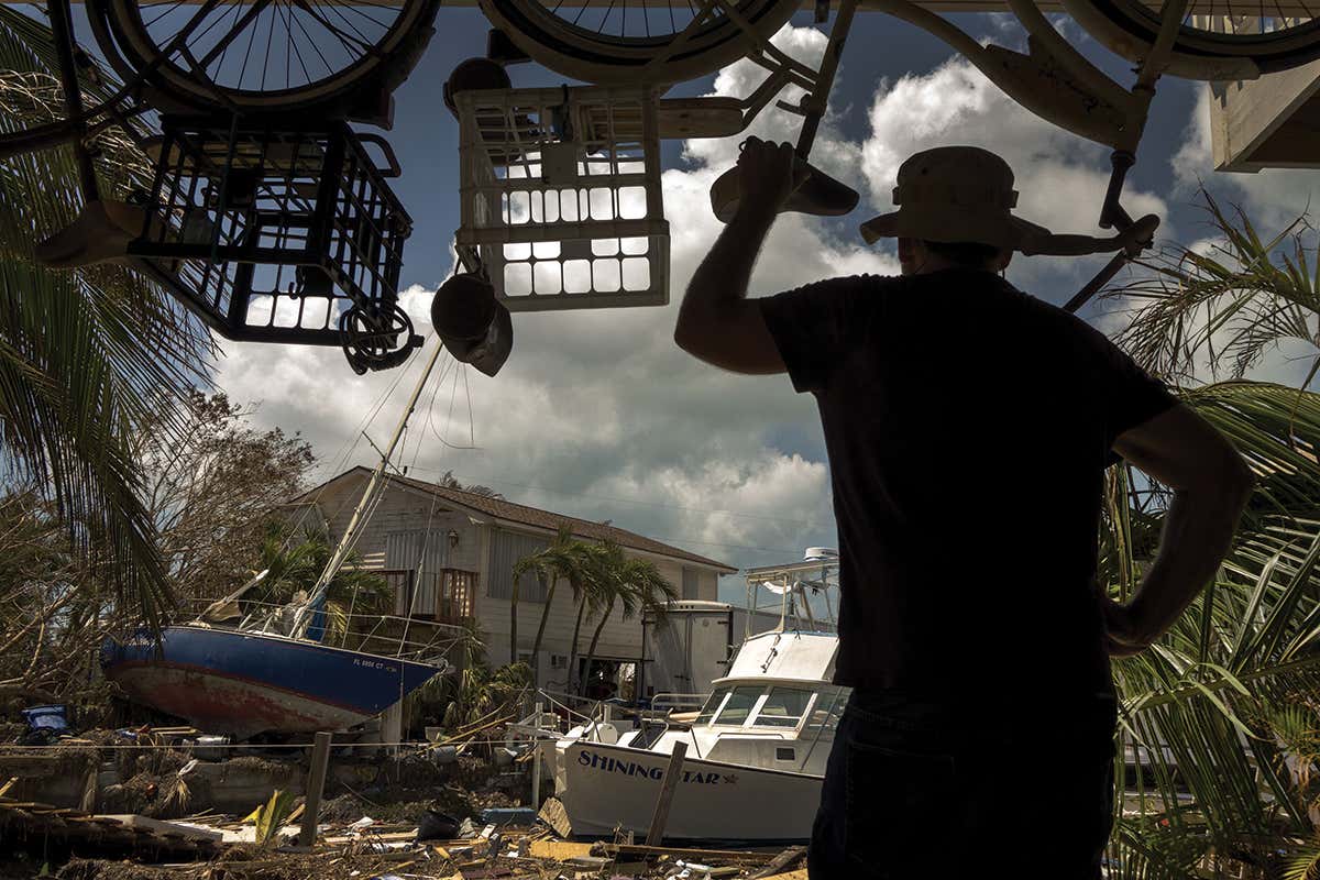 A man looks at devastation from Hurricane Irma