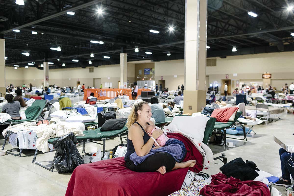A woman and baby in the aftermath of a hurricane