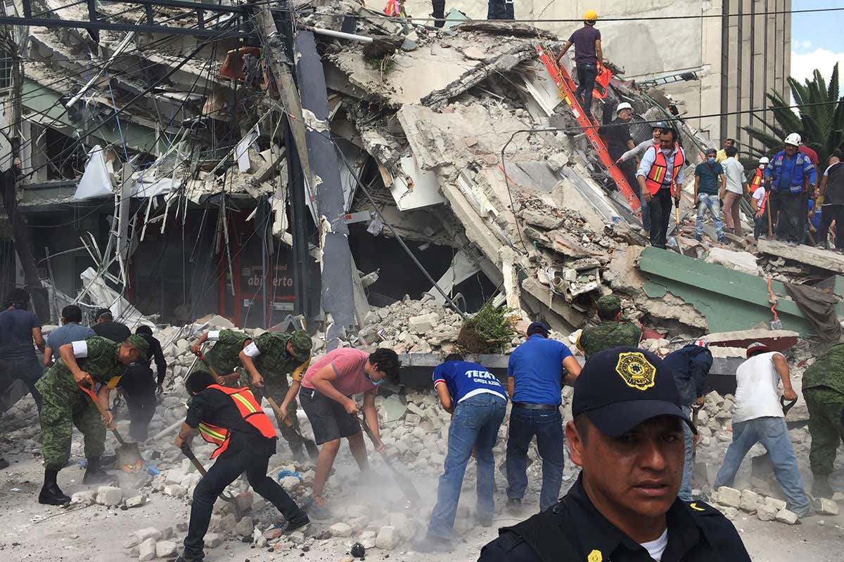 People search for survivors in a collapsed building in the Roma neighborhood of Mexico City