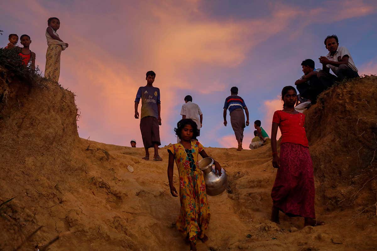 Girl collecting water in refugee camp