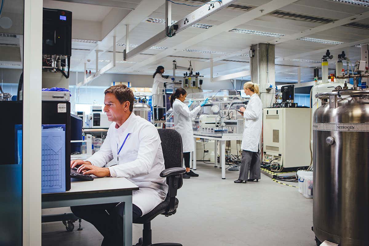 A man in a lab coat at a desk