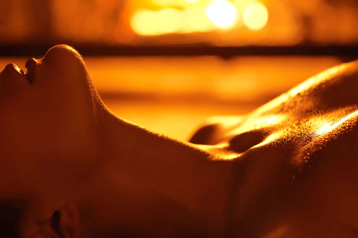 A woman lying down in soft lighting