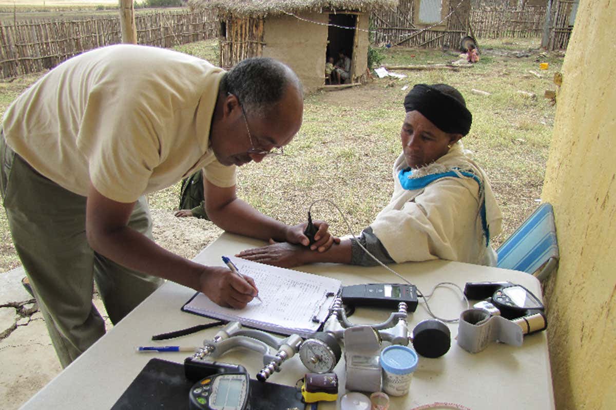 Researcher in the field measures skin colour