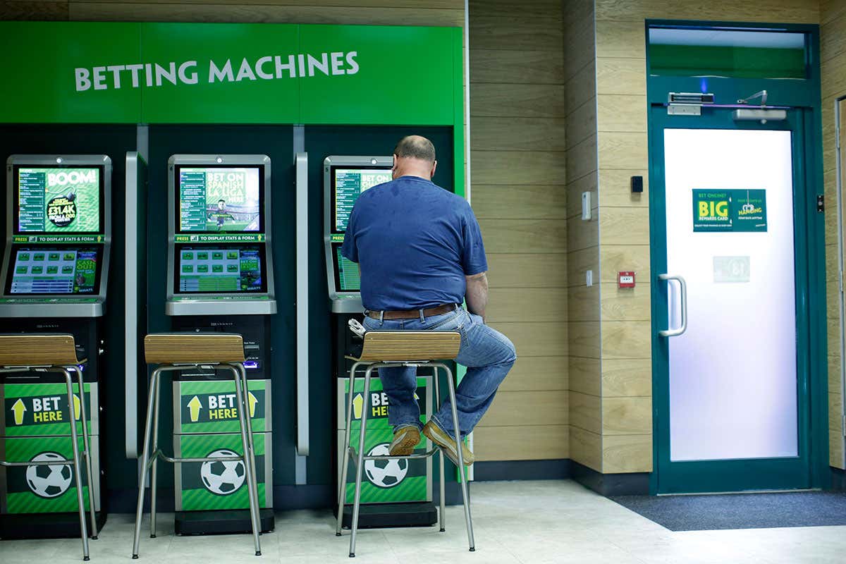 Man sits at betting machines