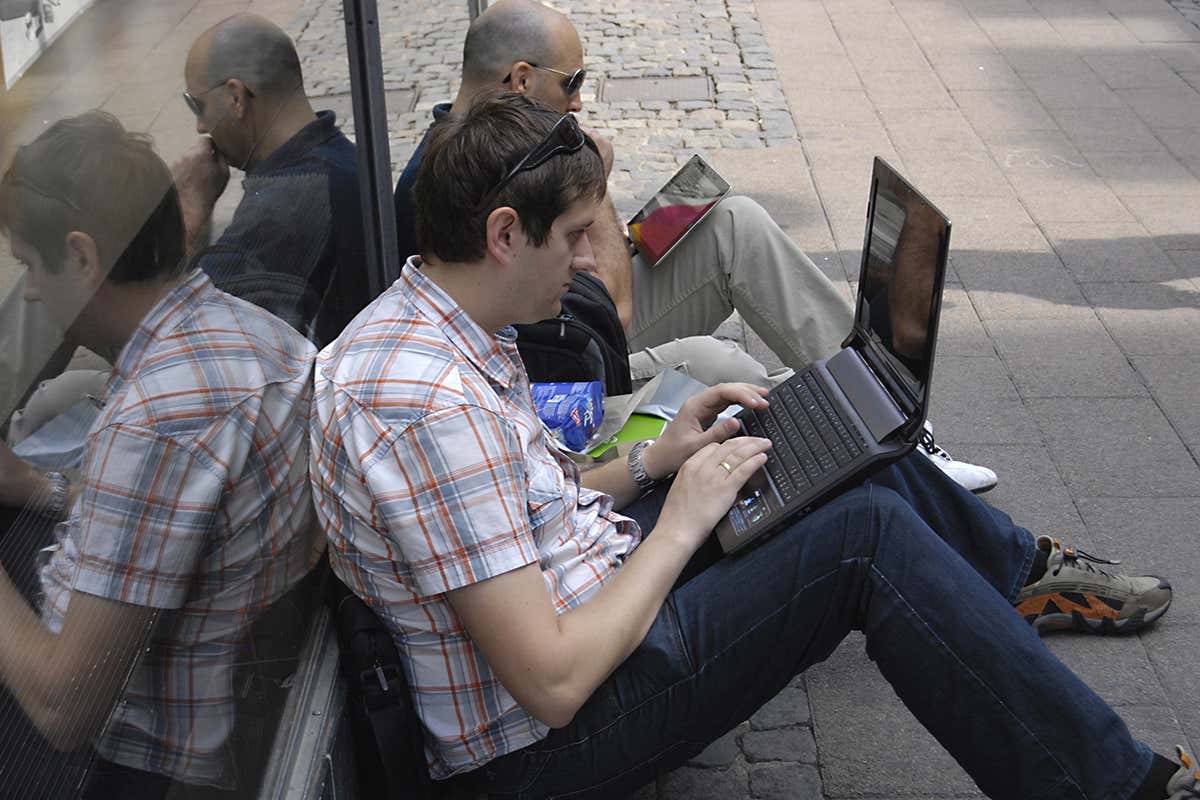 men sitting with laptops