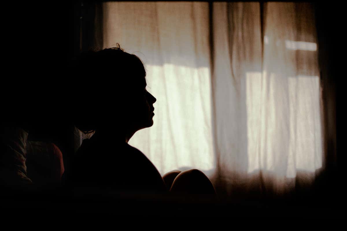 A woman in a dark room