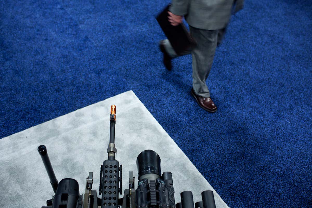 Man walks past weapons