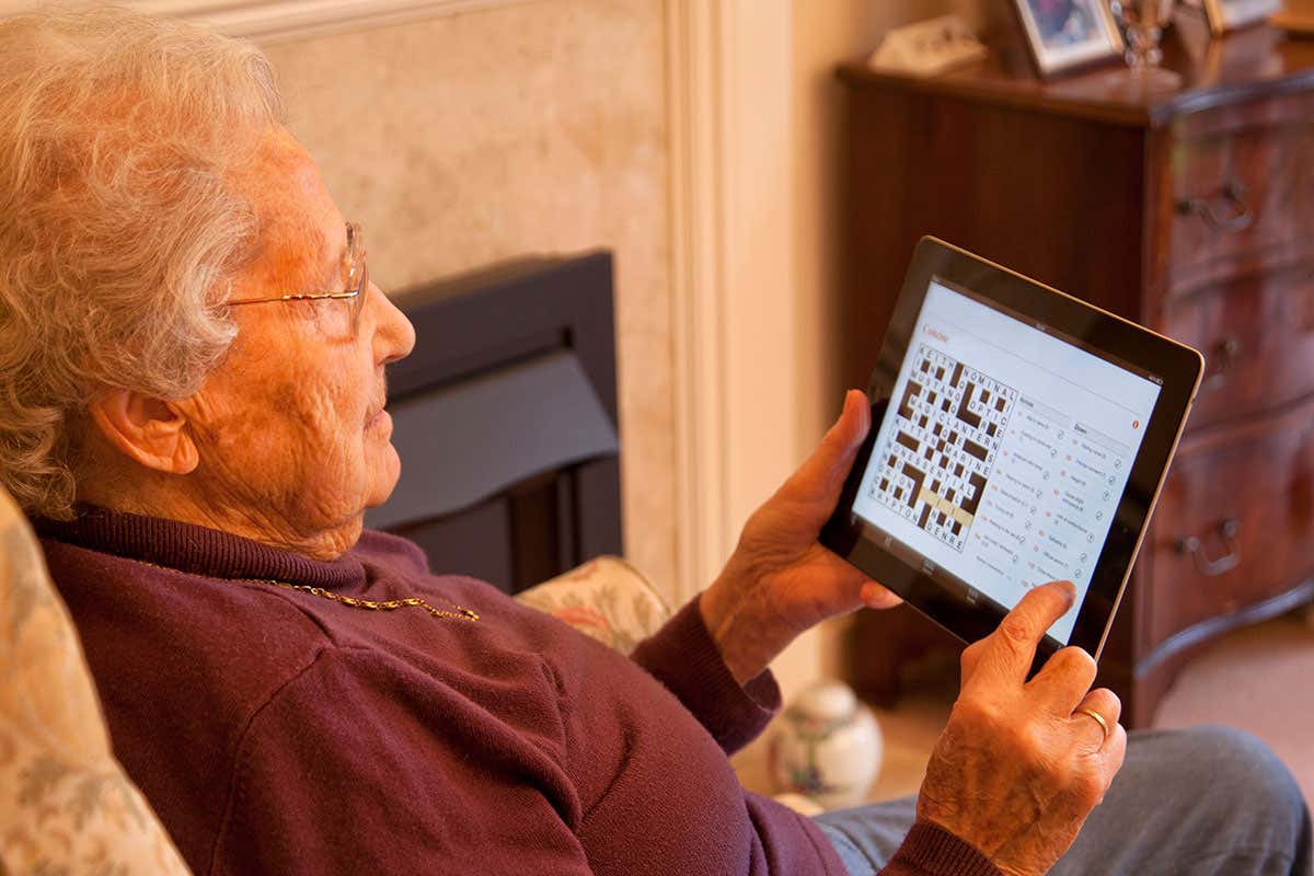 An older person doing a crossword