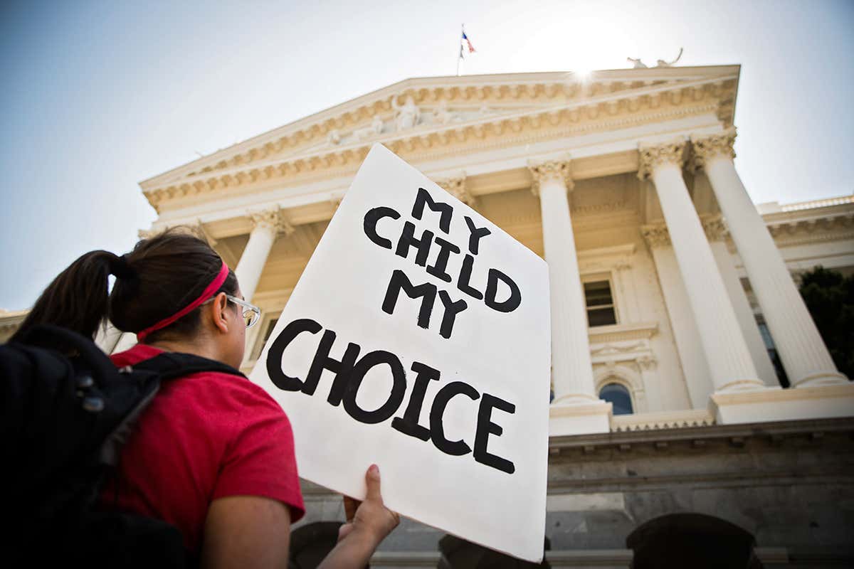 A woman protesting a California bills that removes personal belief exemptions for vaccines