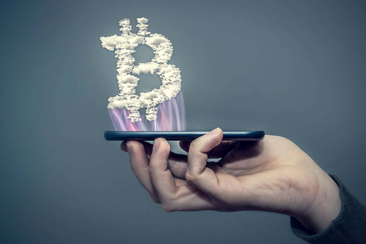 Bitcoin symbol hovering above a cellphone
