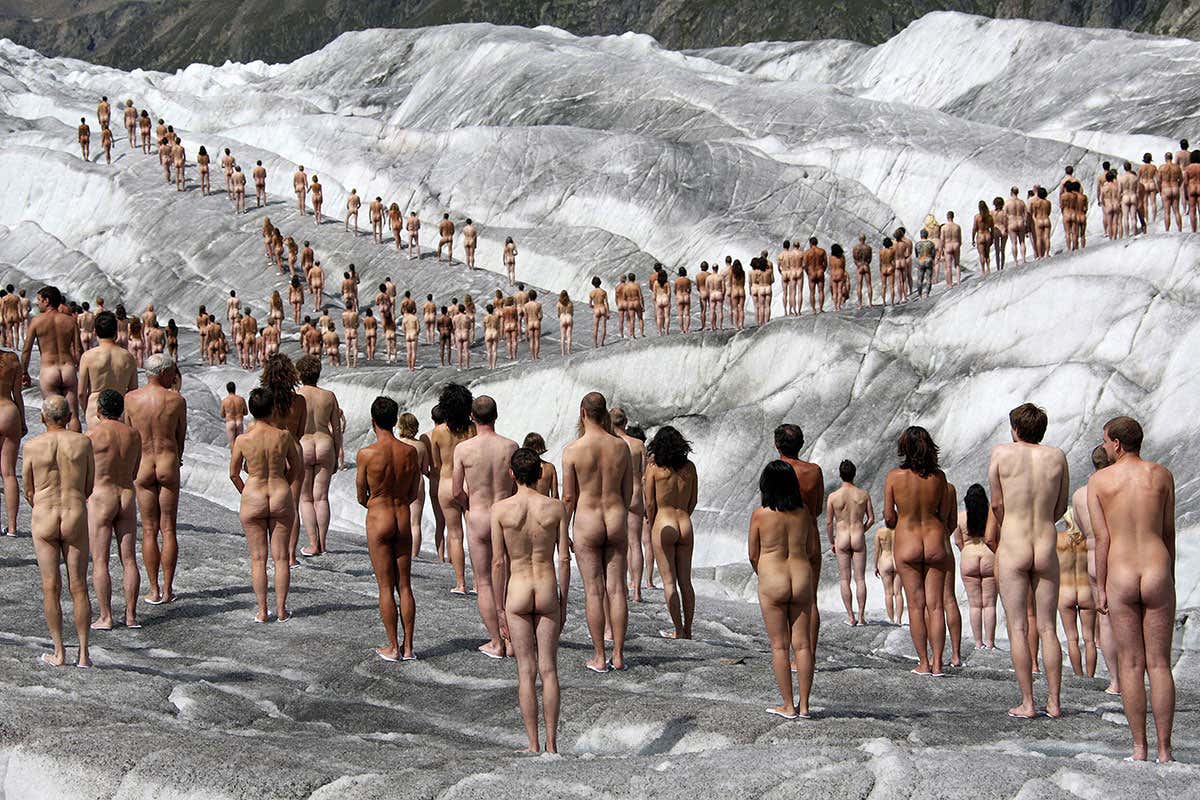 Naked volunteers pose for the US photographer Spencer Tunick in the ice-cold Swiss glacier of Aletsch, the largest in the Alps, as background for an environmental campaign about global warming