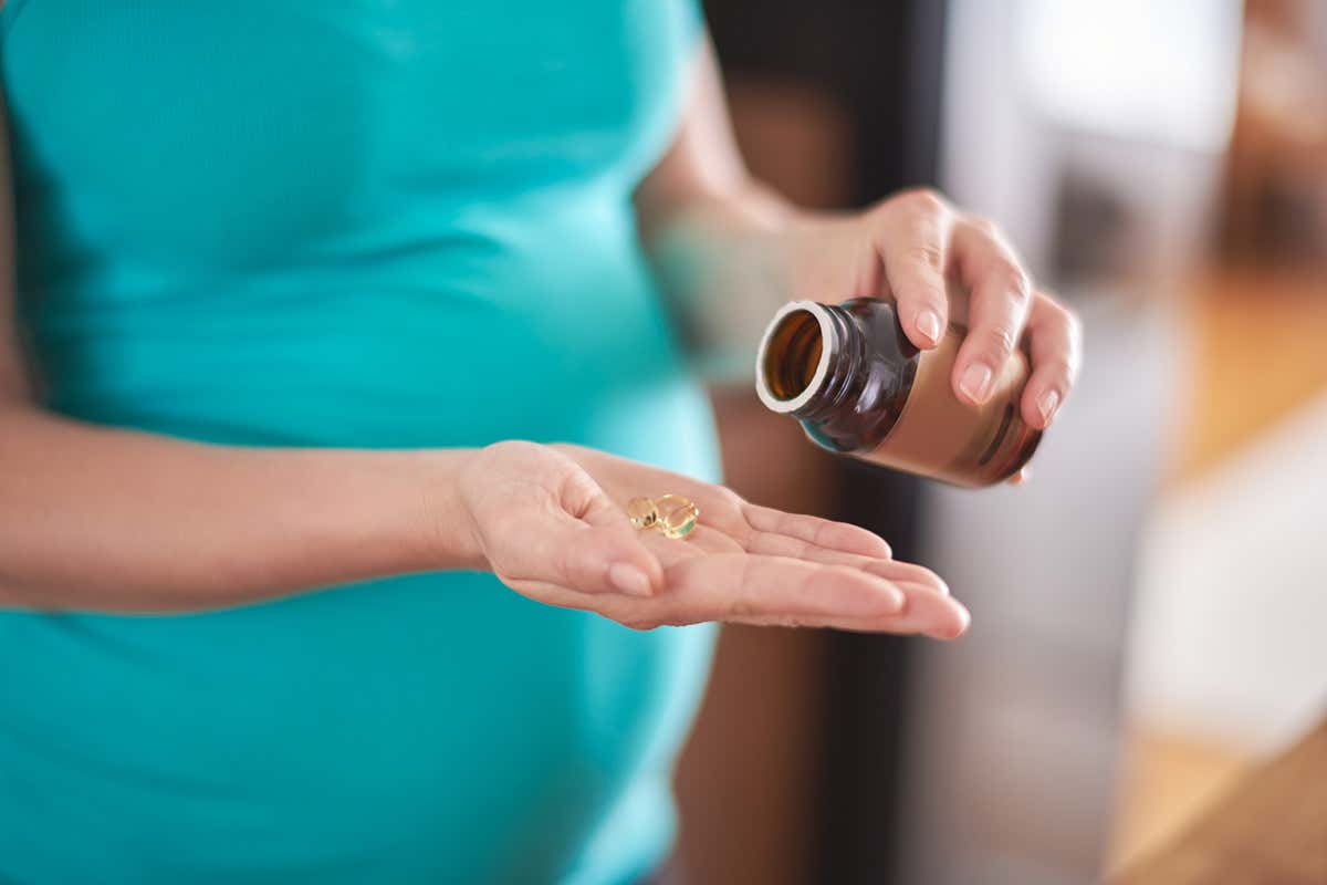A pregnant woman taking supplements