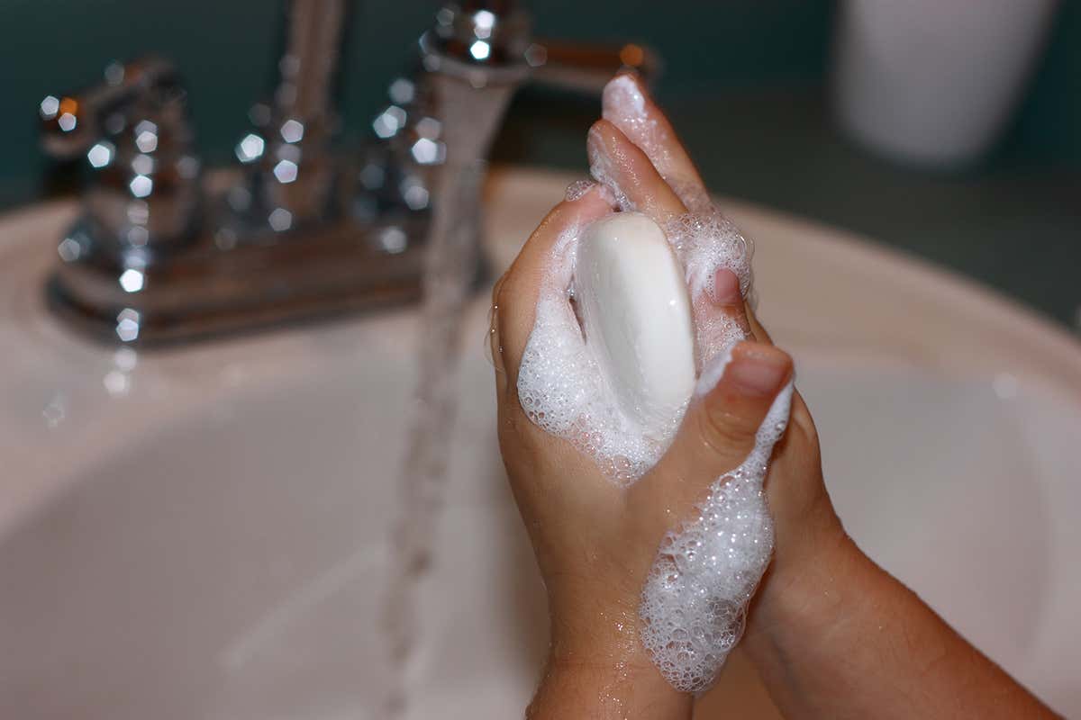 A person washing their hands with soap