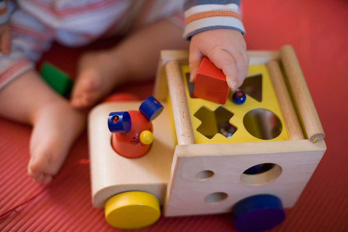 child plays with shaped blocks