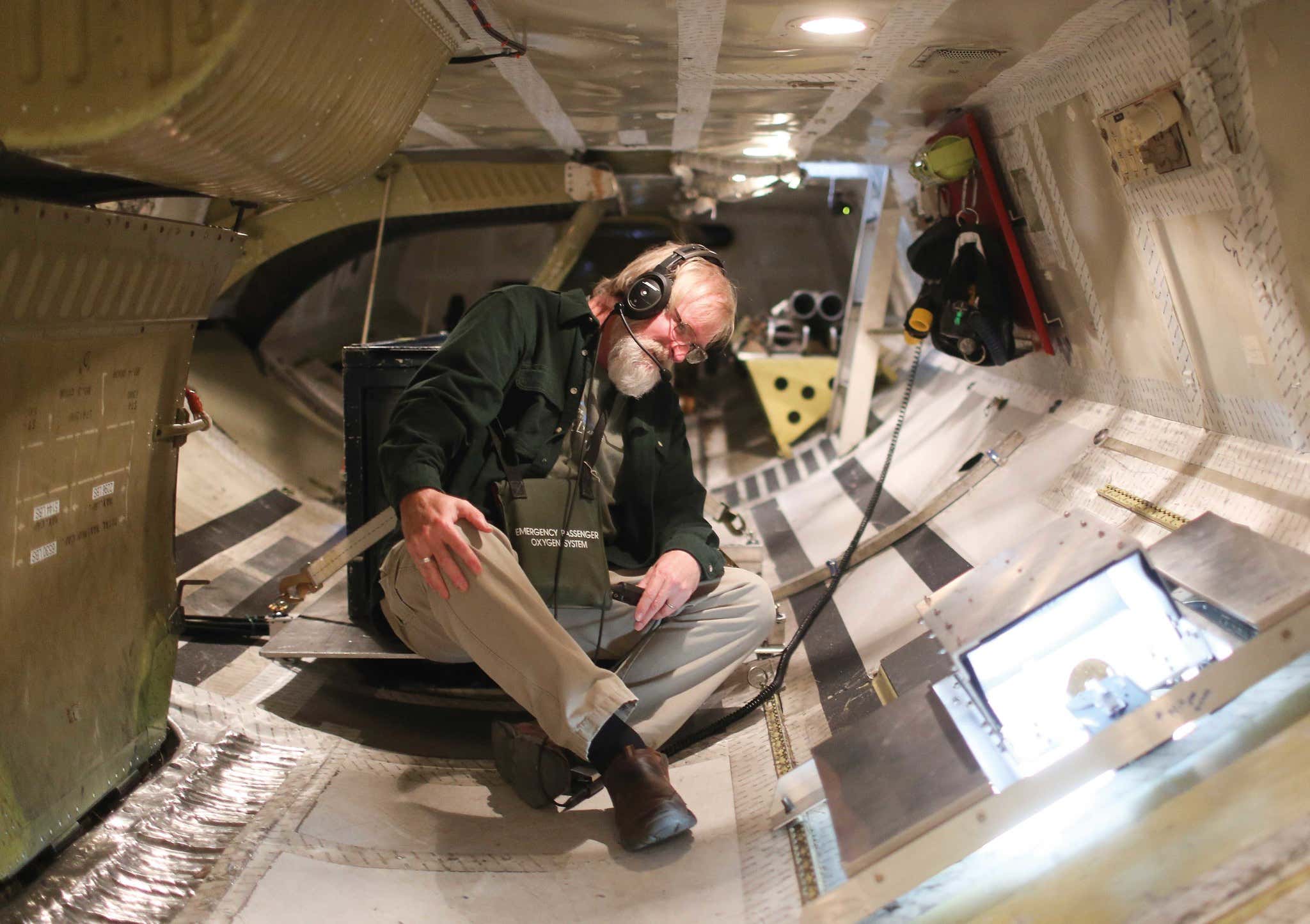 Geoscientist David Gallaher examines instruments in the cargo hold