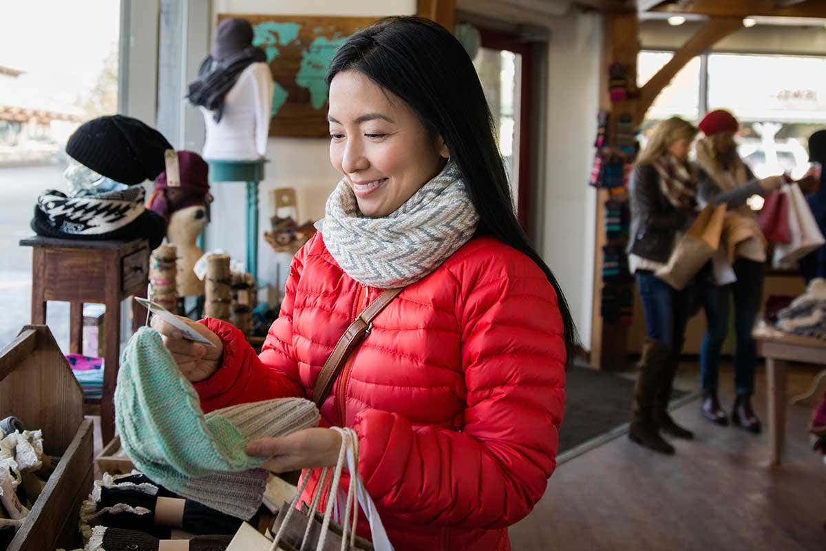 Smiling shopper looks at garment label