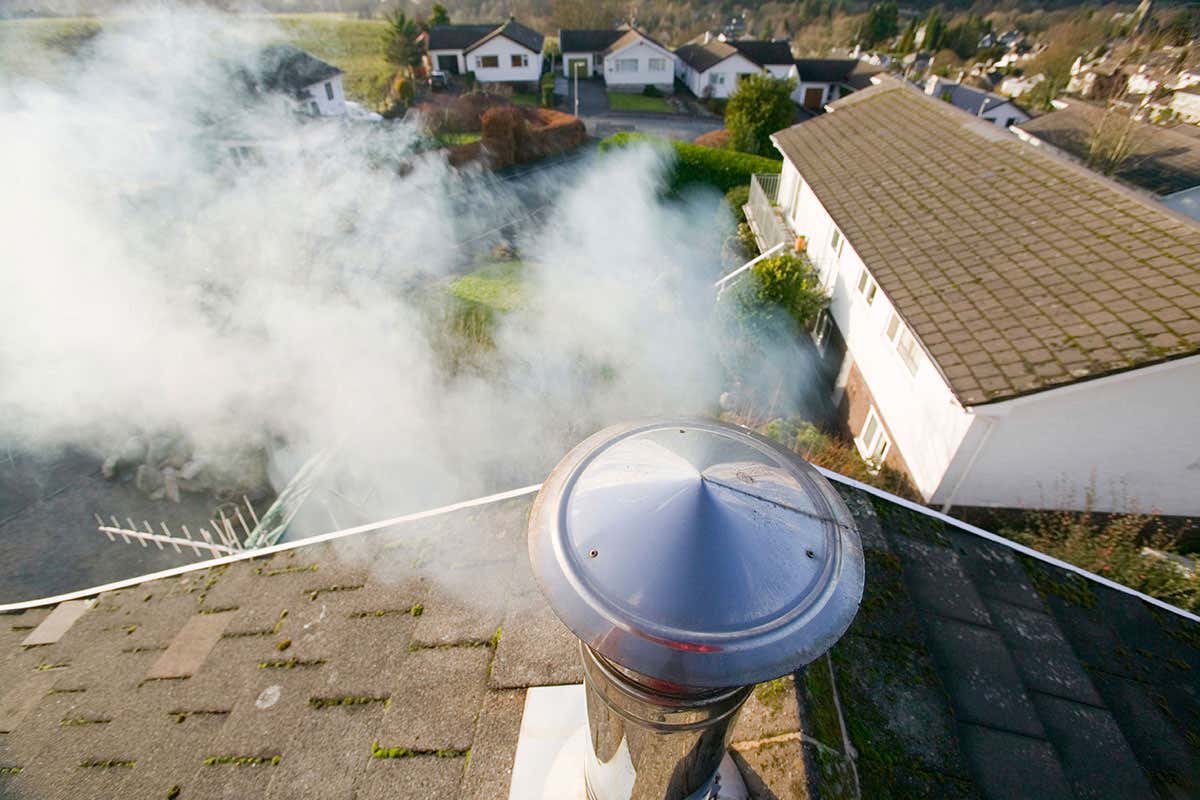 Smoke rises out of a chimney