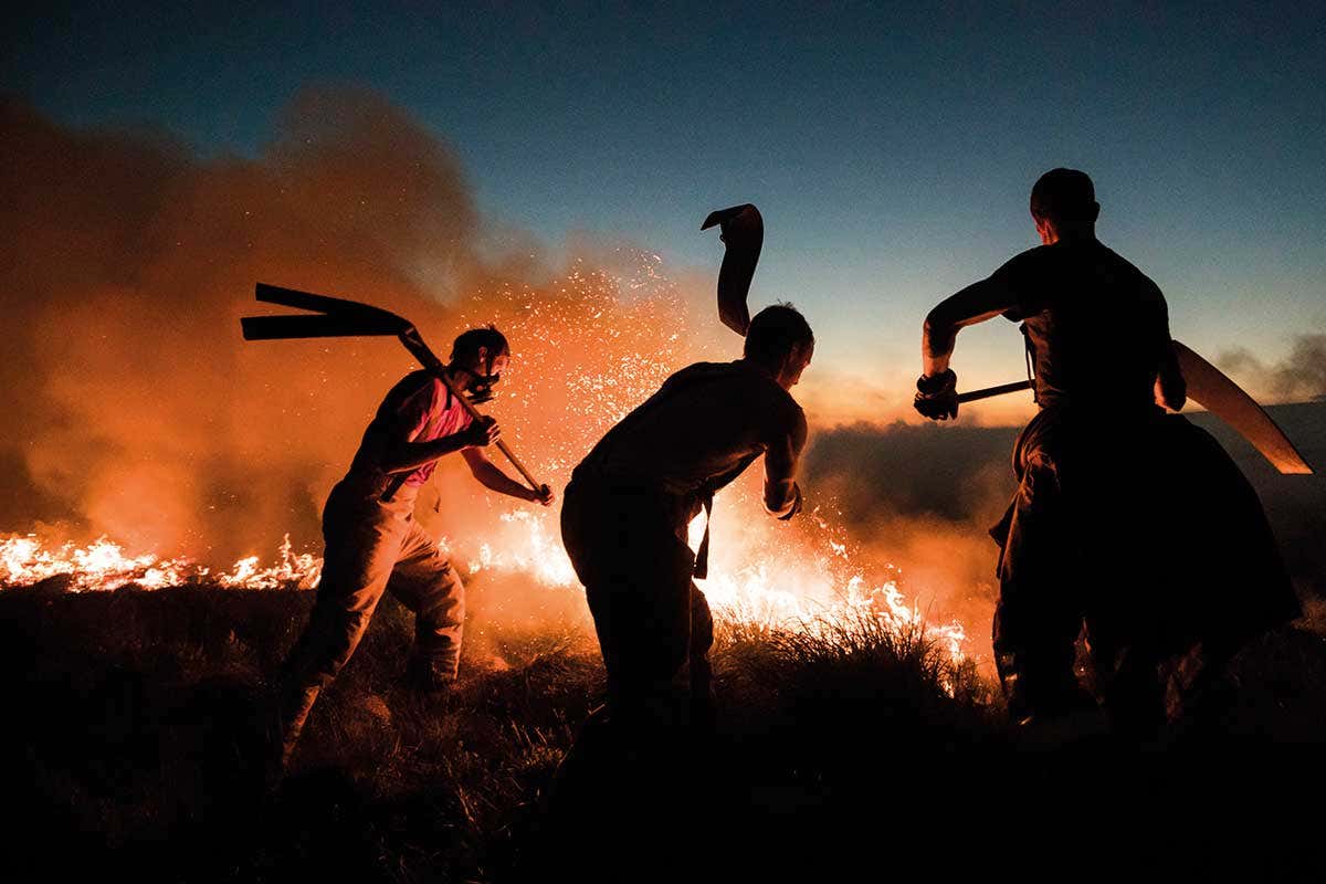 Men trying to put out fire