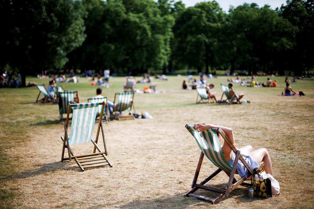 People in park on deck chairs