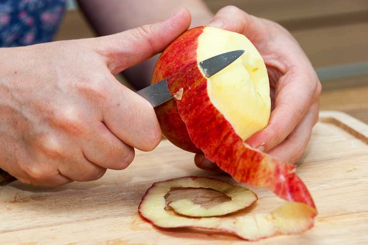 Someone peeling an apple