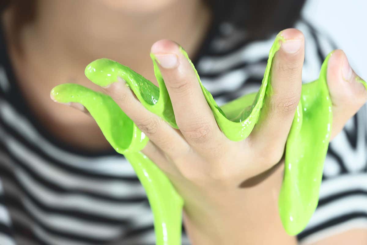 A child playing with green slime