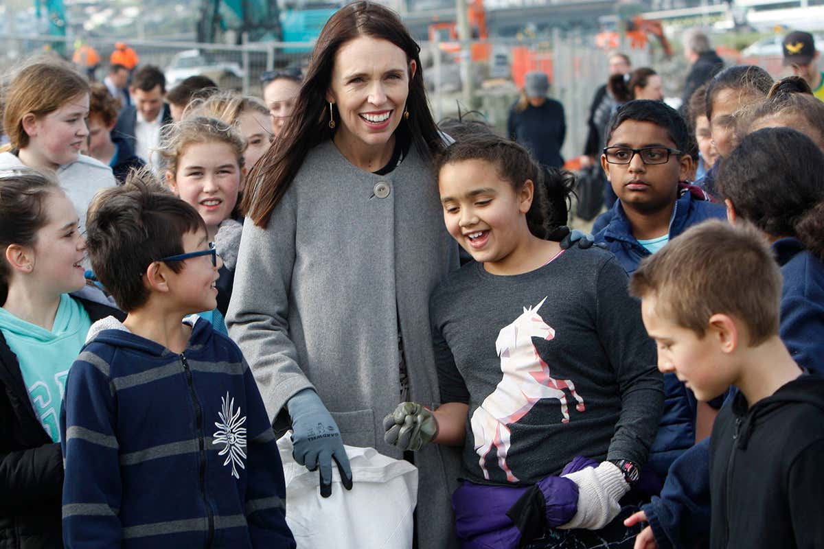 New Zealand Prime Minister Jacinda Ardern leads a beach clean-up