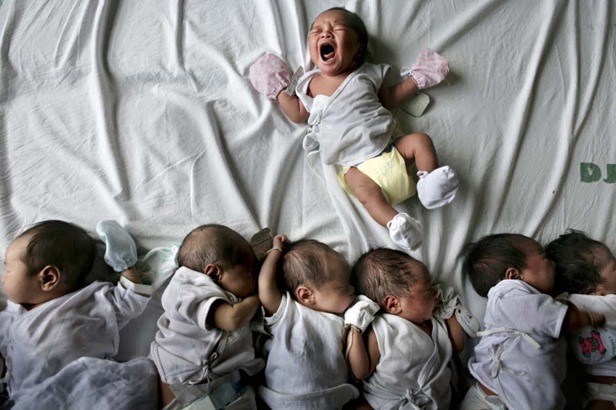 Lots of babies on a bed