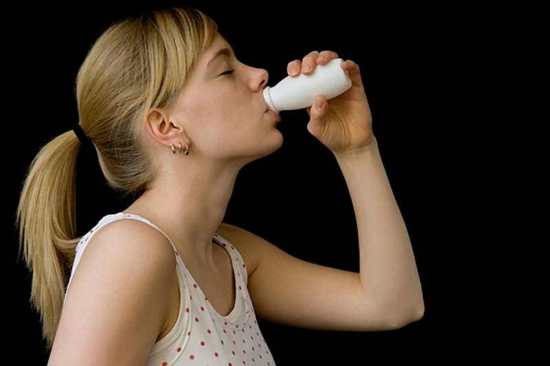 woman drinking probiotic