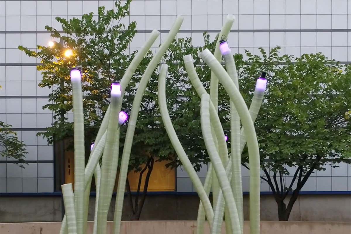 Several robot built tubes rise from the ground