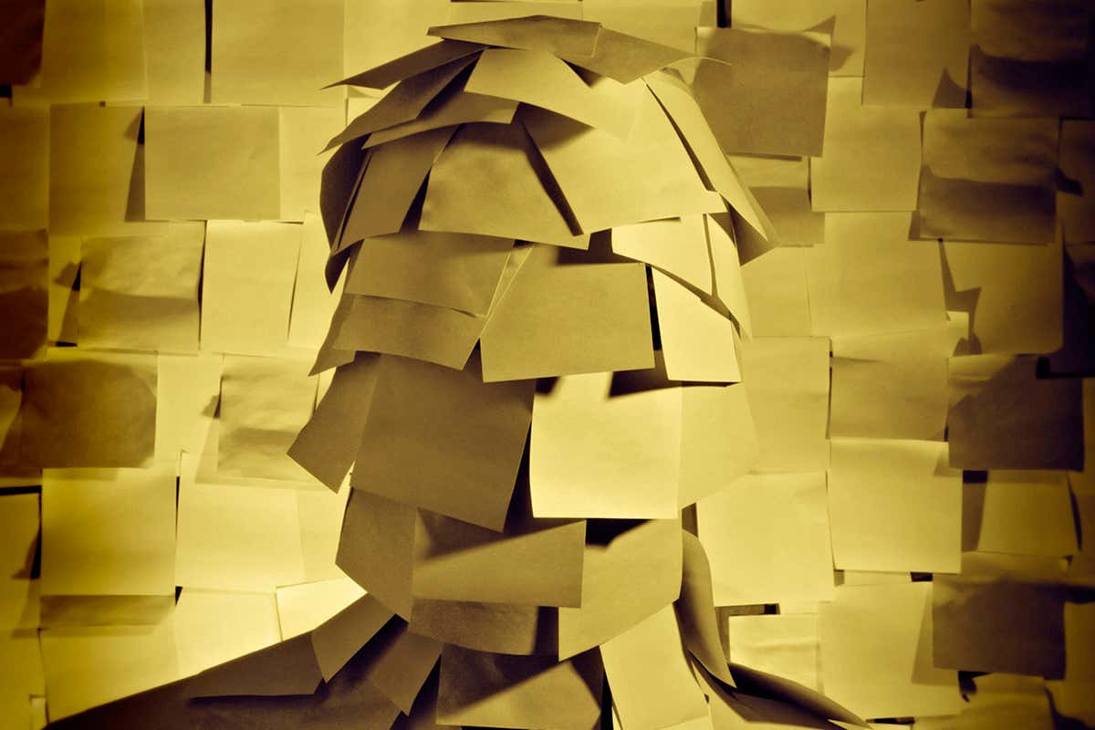 a head covered in sticky notes