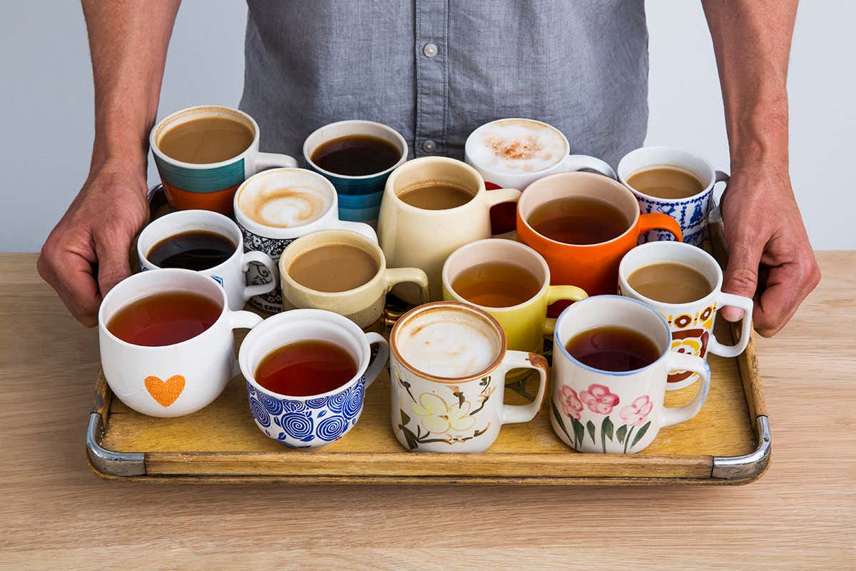 A tray filled with mugs of tea and coffee