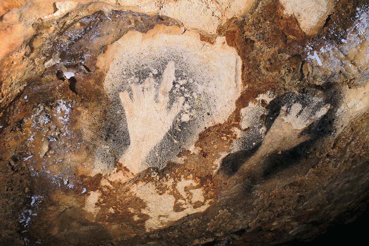 cave art handprint with missing fingers