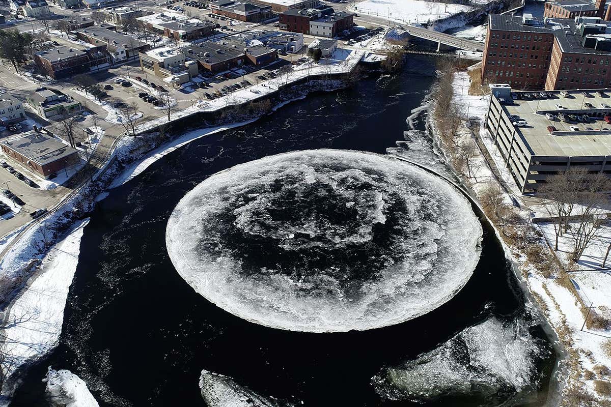 Huge spinning ice disc in river provides a carousel for ducks