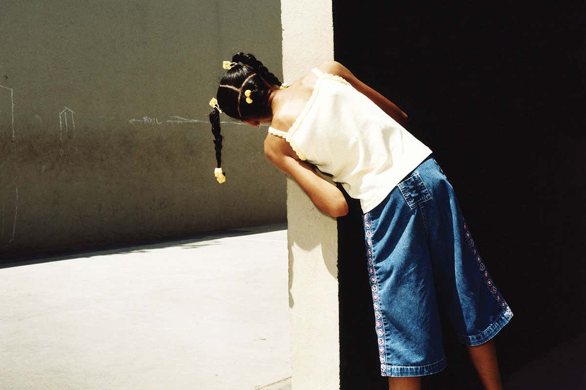 girl looking round corner