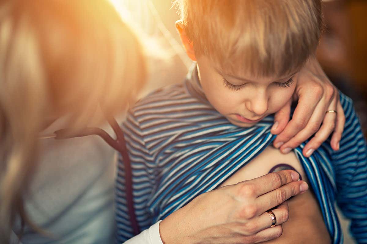 A child gets their chest examined