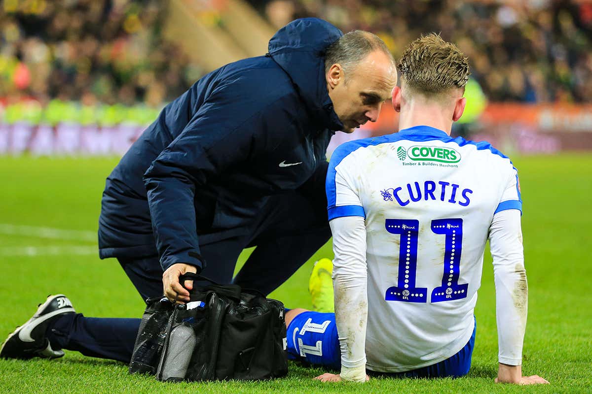 Ronan Curtis (11) of Portsmouth receives medical attention