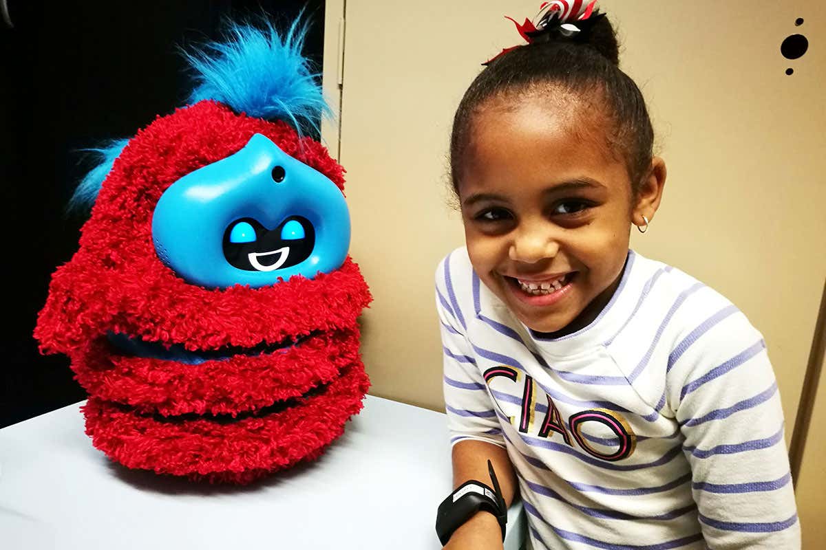 Tega the robot with a smiling child